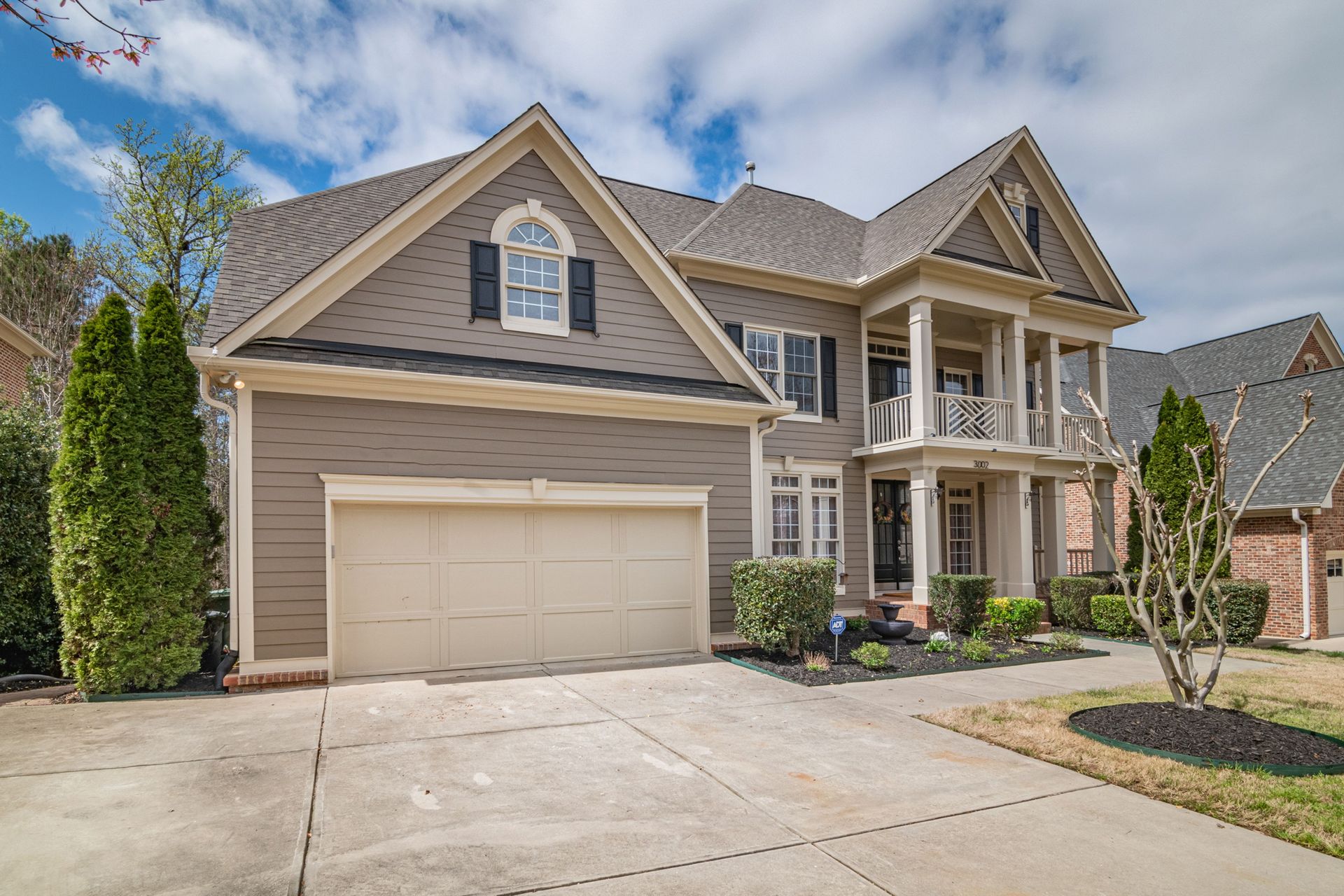 A beautiful suburban home with a spacious front garage and manicured lawns.